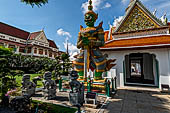 Bangkok Wat Arun - giant demons guarding the gate to the ubosot. Note the chinese dragons at his feet.